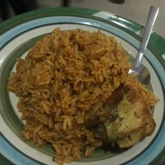 A picture of Jollof rice and fried chicken.