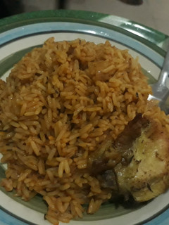 A picture of Jollof rice and fried chicken.