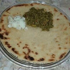 A picture of Sarsoun Ka Saag Maaki Ki Roti Or Makhan.