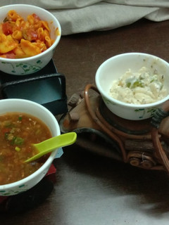 A picture of Penne pasta in red and white sauce with manchow soup.