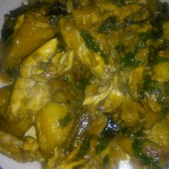 A picture of Porridge plantain with scent leaf and smoked fish.