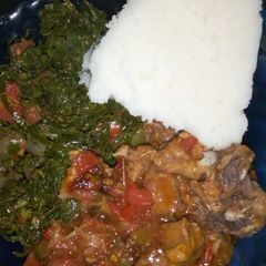 A picture of Ugali, beef stew and kales+ spinach.