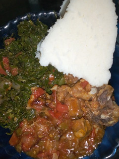 A picture of Ugali, beef stew and kales+ spinach.