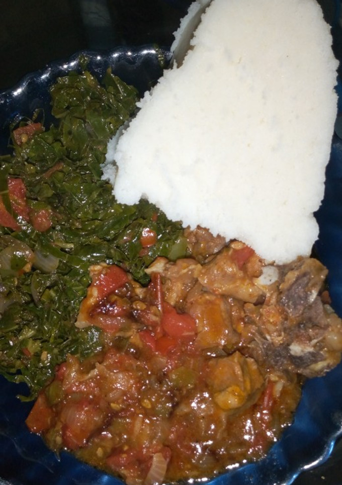 A picture of Ugali, beef stew and kales+ spinach.