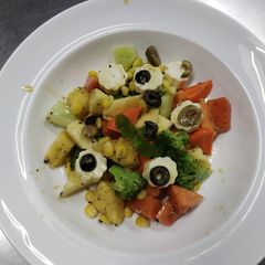 A picture of Healthy salad Fruits and vegetables lemon dressing with black.
