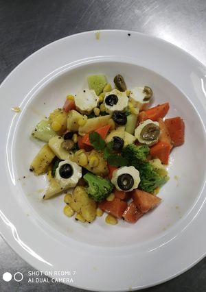 A picture of Healthy salad Fruits and vegetables lemon dressing with black.