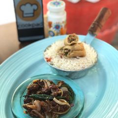 A picture of Crispy beef chilli with egg fried rice.