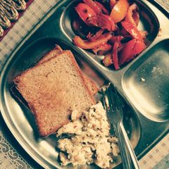 A picture of Toast, eggs and pan seared tomatoes.