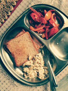 A picture of Toast, eggs and pan seared tomatoes.