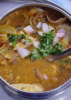 A picture of Kutti idli with sambar and chutney for lunch box.