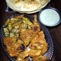 A picture of Chicken Masala Tikka with Grilled Potato Wedges.