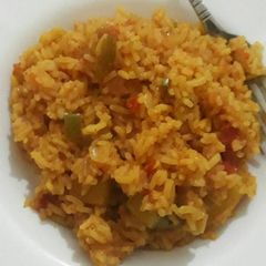 A picture of Cooked rice with matoke.