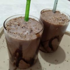 A picture of Cold coffee with chocolate syrup.