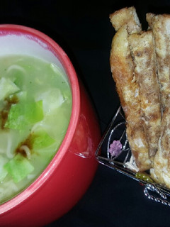 A picture of Cabbage noodles soup with potato masala sticks.
