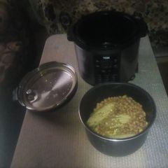 A picture of Teresiah cooking Githeri (dry beans and maize) and 'mutungo'.