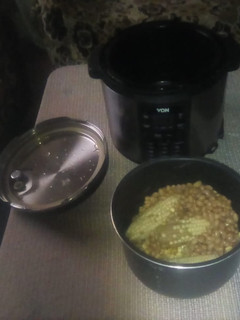 A picture of Teresiah cooking Githeri (dry beans and maize) and 'mutungo'.