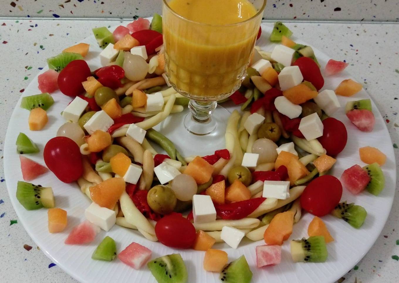 Ensalada de pasta, verduras y frutas con crema vegetal