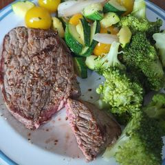 A picture of Beef steak with roasted vegetable.