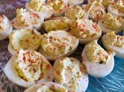A picture of deviled eggs with pickles