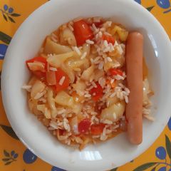 A picture of Hungarian Lecsó with rice and hot-dog.