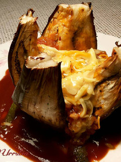 Una foto de Berenjena rellena al horno, con salsa de picadillo de tomate y queso