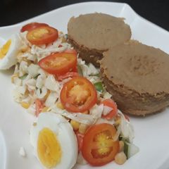 A picture of Moi moi with salad and egg.