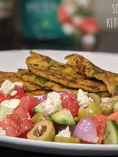 A picture of Cucumber and Spinach Pancakes with Greek Salad.