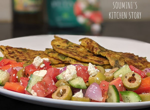 A picture of Cucumber and Spinach Pancakes with Greek Salad.