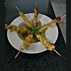 A picture of Chicken skewer with peanut sauce.