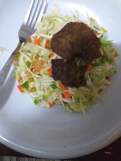 A picture of Salad with fried meat.