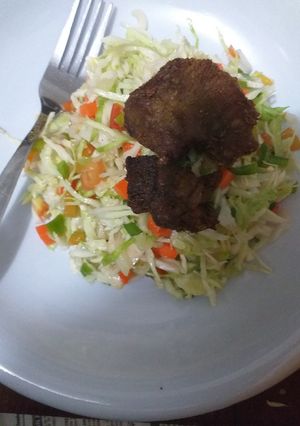 A picture of Salad with fried meat.