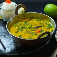 Lasooni Dal Palak with Gondhoraj lebu/ lemon A picture of Lasooni Dal Palak with Gondhoraj lebu/ lemon.