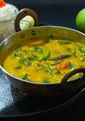 A picture of Lasooni Dal Palak with Gondhoraj lebu/ lemon.