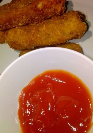 A picture of Potato croquettes with ketchup.
