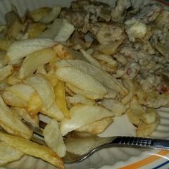 A picture of Chips and scrambled eggs with sardine.
