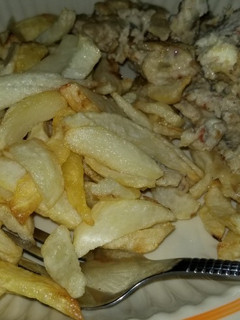 A picture of Chips and scrambled eggs with sardine.