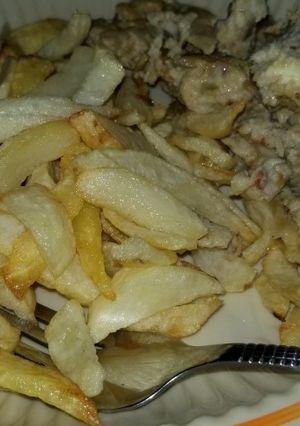 A picture of Chips and scrambled eggs with sardine.