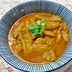 A picture of Stuffed torai in onion gravy.