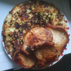 A picture of Pea's in Hash Brown with Pork Chops.