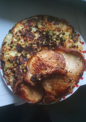 A picture of Pea's in Hash Brown with Pork Chops.