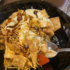 A picture of Papri chaat (chick peas salad garnished with snacks).