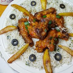 Buffalo hot wings with fried spring onions rice A picture of Buffalo hot wings with fried spring onions rice.