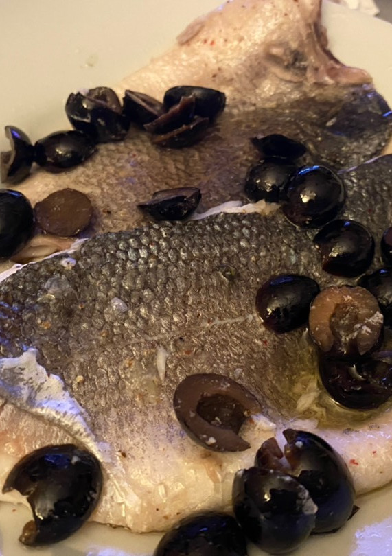 Una foto de Lubina al horno con aceitunas y limón