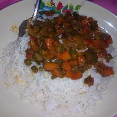 A picture of Rice and veggie sauce.