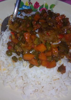 A picture of Rice and veggie sauce.