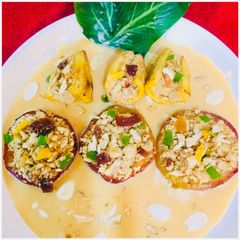 A picture of Dry fruits stuffed baked apples and bananas in Rabri.