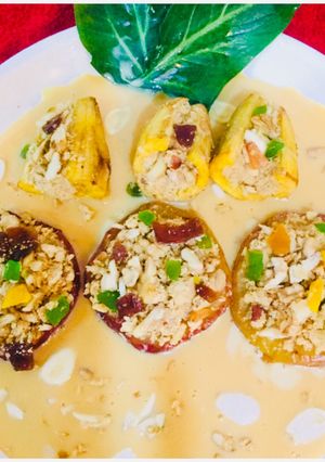 A picture of Dry fruits stuffed baked apples and bananas in Rabri.