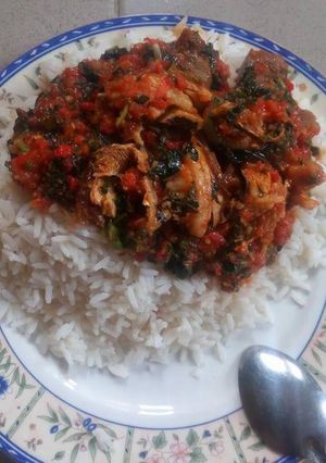 A picture of White rice with vegetable sauce.