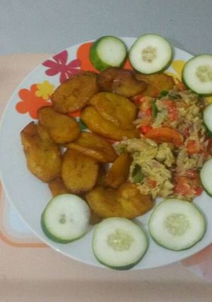 A picture of Fried plantain with fried egg and cucumber.
