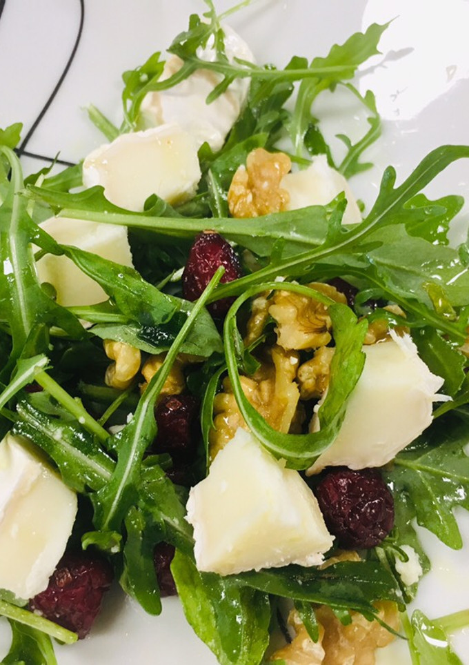 Una foto de Ensalada de rúcula, nueces, arándanos y queso de cabra